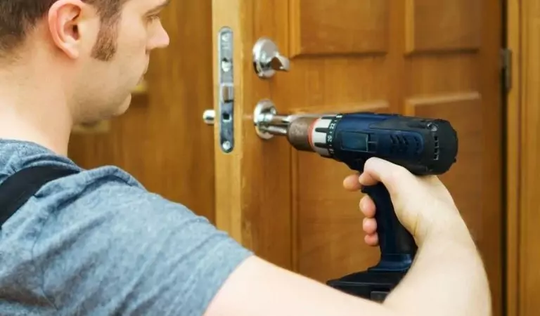 professional installing a lock on the door